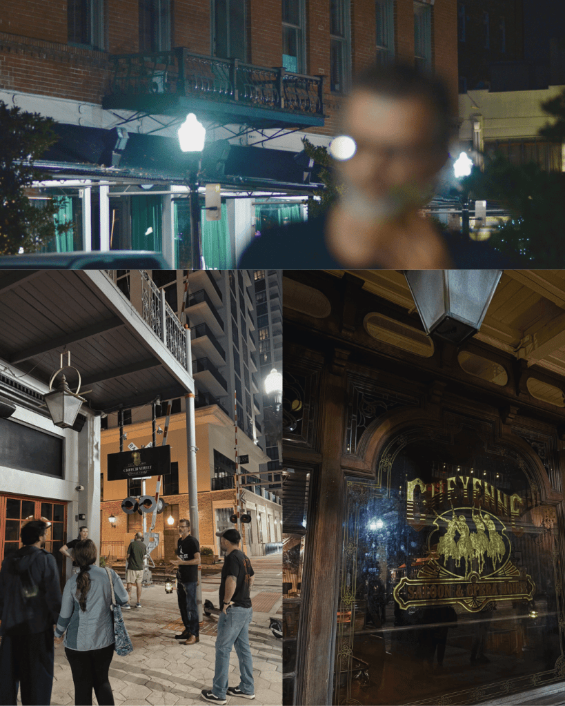 A night scene featuring a restaurant with outdoor seating under street lamps, and a group of people gathered outside. Different angles showcase a building's upper balcony and the entrance of a saloon named 'Cheyenne'.